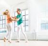 Older couple dancing in a white room