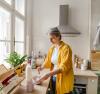 Woman in the kitchen making cereal